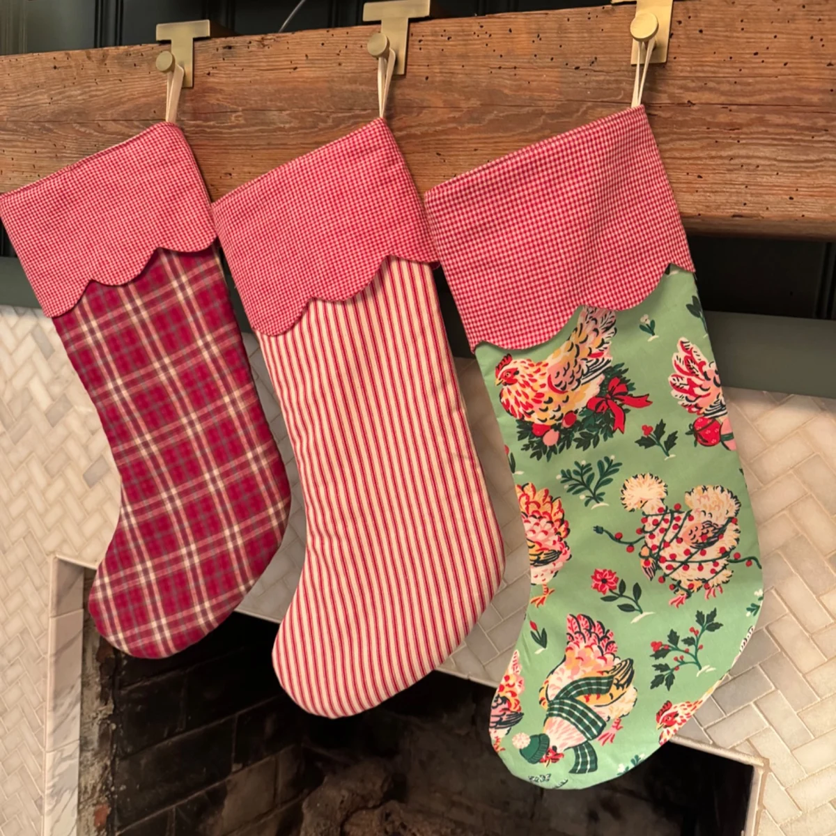 Three handmade Christmas stockings with scalloped gingham cuffs