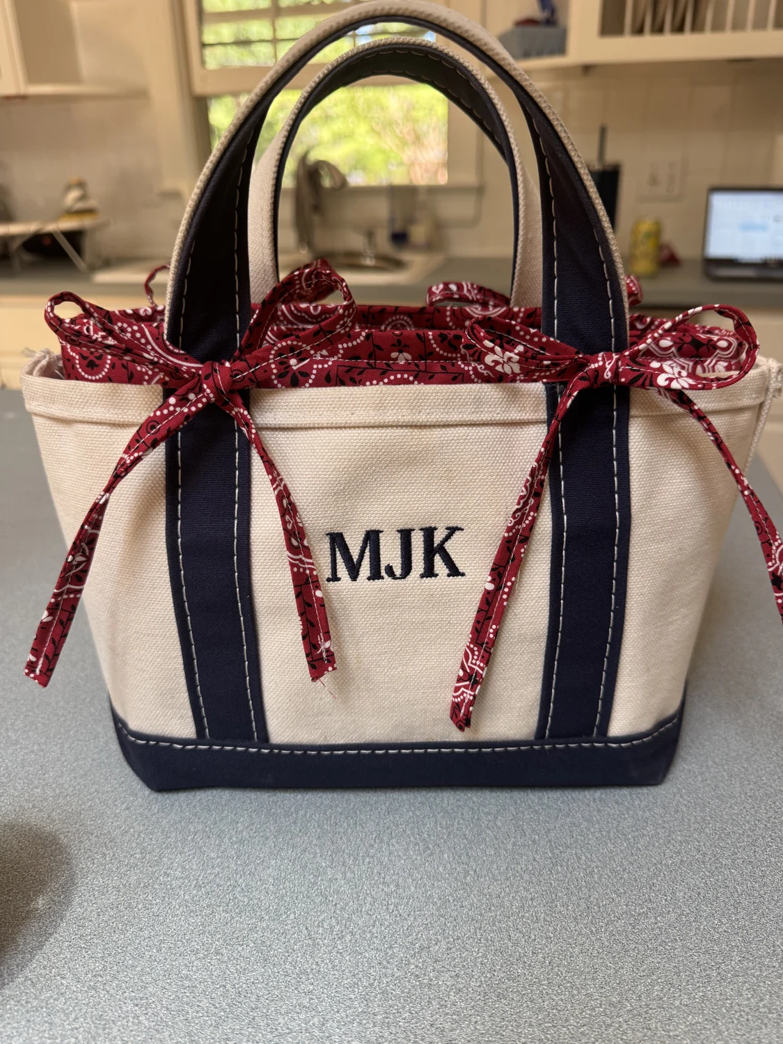 Sandy tote liner in a red bandana print inside a monogrammed tote