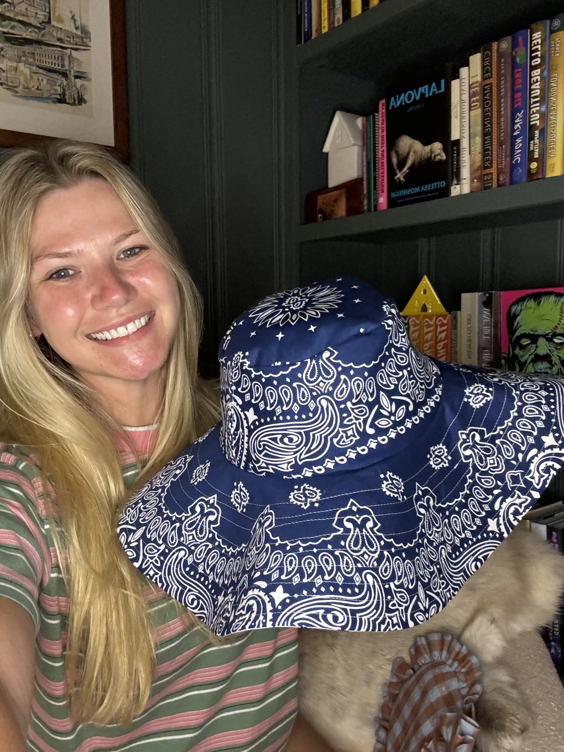 Molly holding a blue bandana-print Pippa Sun Hat