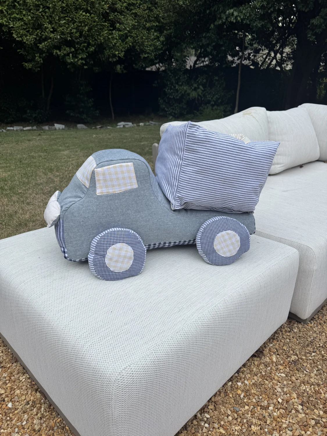 Handmade gingham truck cushion on an outdoor sofa
